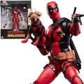 Deadpool action figure holding a dog with packaging in the background