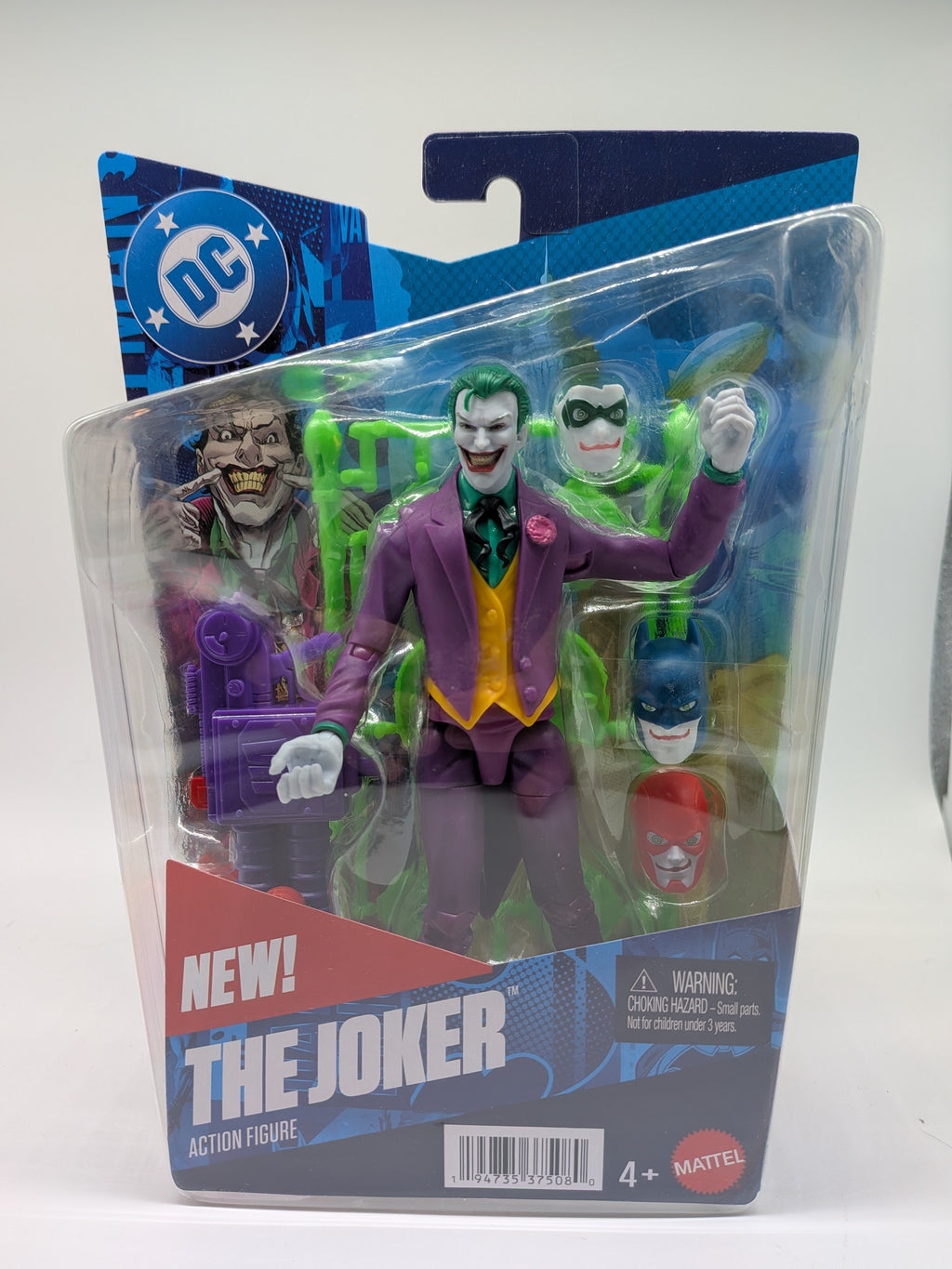 Action figure of The Joker in packaging with DC logo