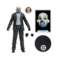 Action figure of the Joker clown with accessories and a DC logo on a white background